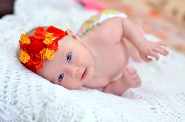 Mooie glimlachende baby met een felle rode kleur op het haar — Stockfoto