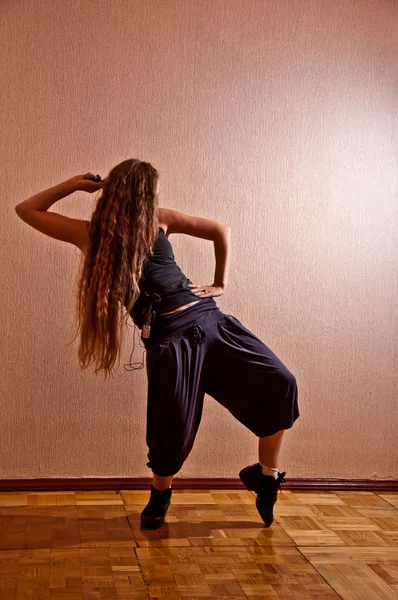 Beautiful girl with long hair dancing — Stock Photo, Image