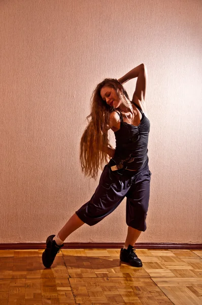 Beautiful girl with long hair dancing — Stock Photo, Image