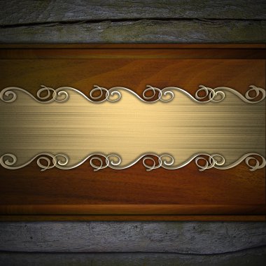 Gold pattern on a gold plate on a wood background