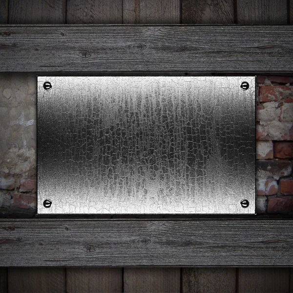 Metal plaque on a wooden background. Design template — Stock Photo, Image