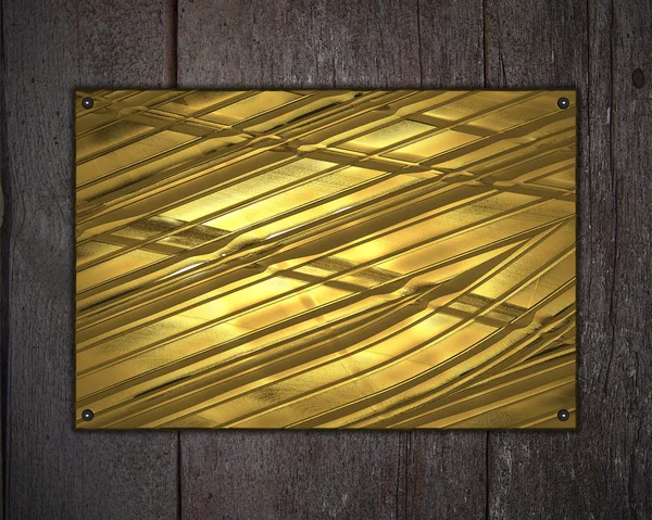 ゴールド銘板と木製の背景 — ストック写真