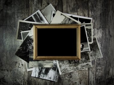 fotoframe met veel foto's liggend op een oude tafel