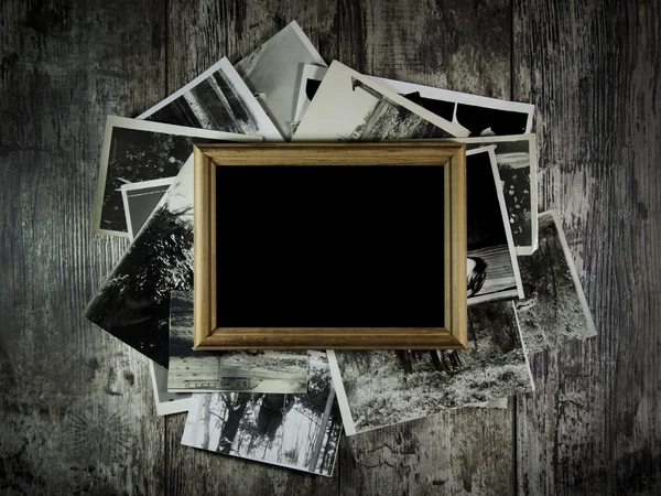 Photo frame with lots of photos lying on an old table — Stock Photo, Image