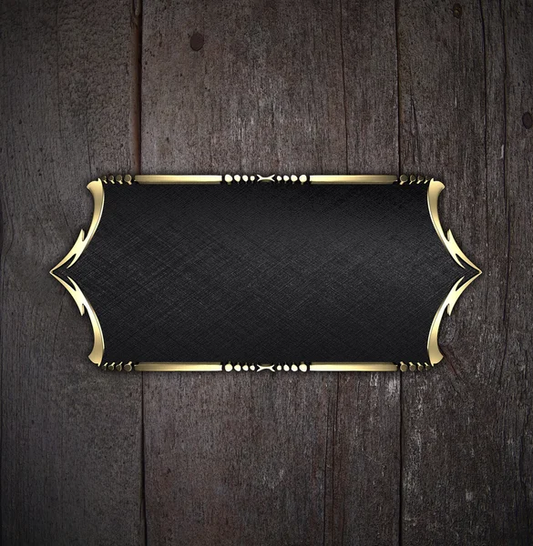 Zwarte naamplaatje met gouden sierlijke randen, op houten achtergrond — Stockfoto