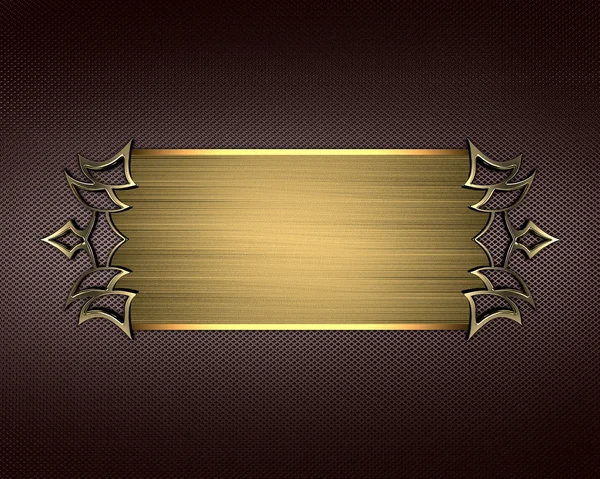 Золотая табличка с золотыми декоративными краями на коричневом фоне — стоковое фото