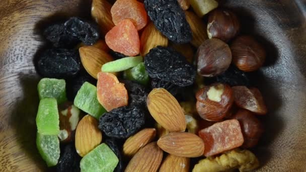 Dried fruits are rotated in a wooden plate — Stock Video