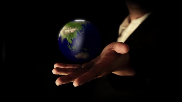 Earth rotating in hand — Stock Video