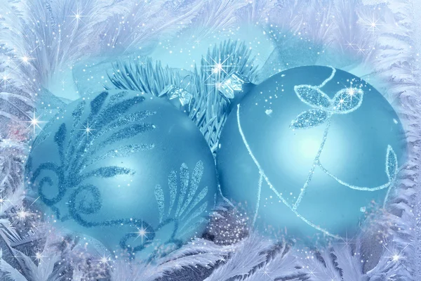 Blue Christmas balls on beautiful frost crystal pattern — Stock Photo, Image