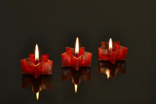 Red candles on dark background — Zdjęcie stockowe
