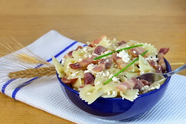 Bow-tie pasta with bacon and cheese — Stock Photo, Image