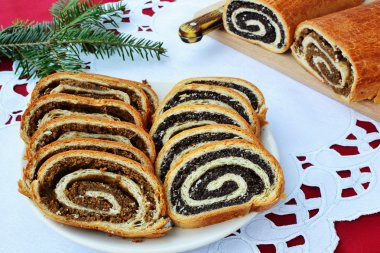 Beigli - dilimlenmiş ceviz ve haşhaş tohumu yuvarlanıyor.