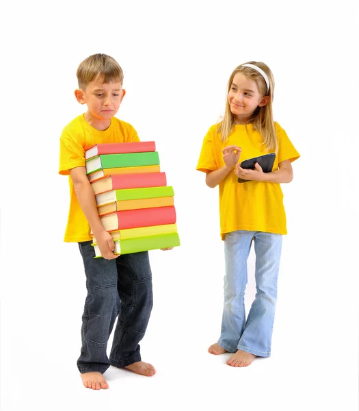 Boy with heavy books, girl has an e-book — Stock Photo, Image