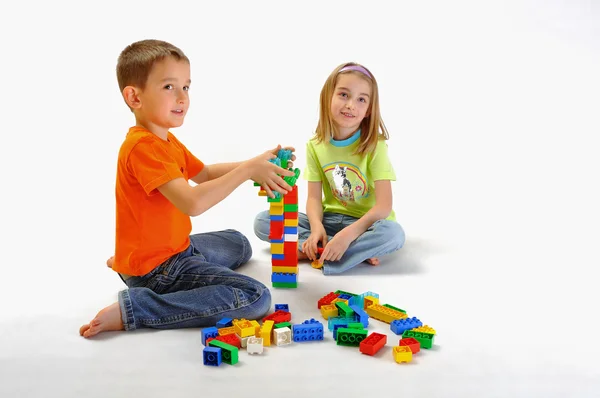 Two children boy and girl playing with constructor — Stock Photo, Image