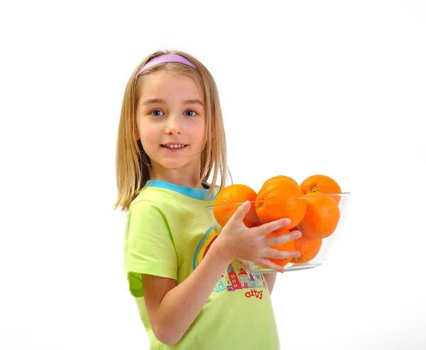 Menina com laranjas isoladas em branco — Fotografia de Stock