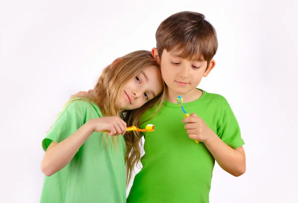 Health - boy and girl brush their teeth with toothbrushes — Stock Photo, Image