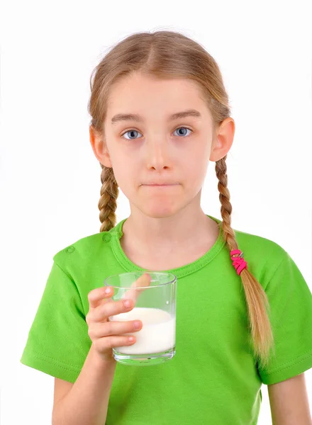 Girl tasting a glass of milk — Stock Photo, Image