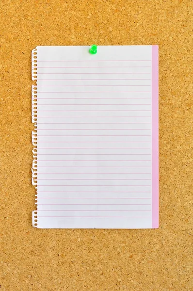 Sheet of notebook pinned on cork bulletin board — Stock Photo, Image