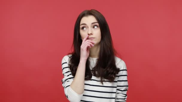 Portrait of brunette woman holding finger in her nose, uncultured bored girl having fun, bad manners, wearing casual style long sleeve shirt. Indoor studio shot isolated on red background. — Stock Footage Portrait Brunette Woman Holding Finger Her Nose Uncultured Bored Girl Stock Video