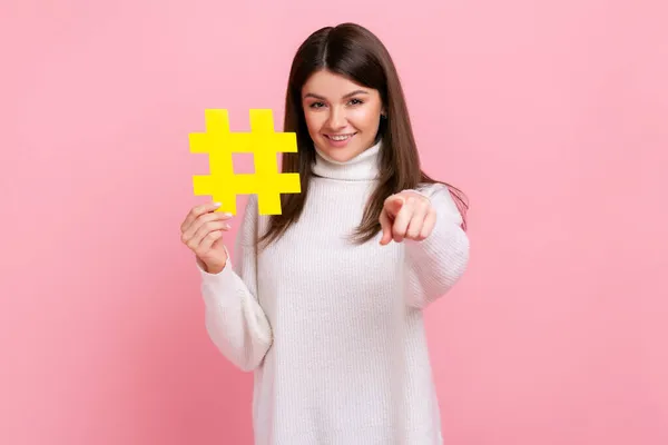 Portrait Happy Brunette Woman Toothy Smile Pointing Camera Holding Yellow — Stock Photo, Image