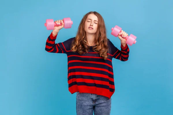 Exhausted Woman Wearing Striped Casual Style Sweater Raising Heavy Dumbbells — Stok fotoğraf