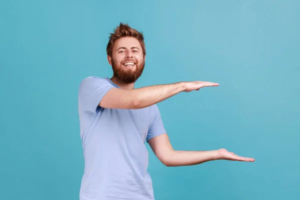 Portrait Young Adult Positive Optimistic Bearded Man Presenting Area Advertisement — Φωτογραφία Αρχείου