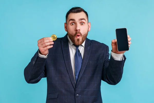 Astonished Young Adult Bearded Man Wearing Official Style Suit Holding — Stok fotoğraf