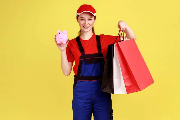 Portrait Happy Courier Woman Standing Shopping Bags Hands Piggybank Cashback — Stockfoto