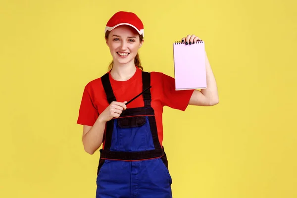 Portrait Satisfied Delighted Handy Woman Standing Pointing Paper Notebook Smiling — Fotografia de Stock