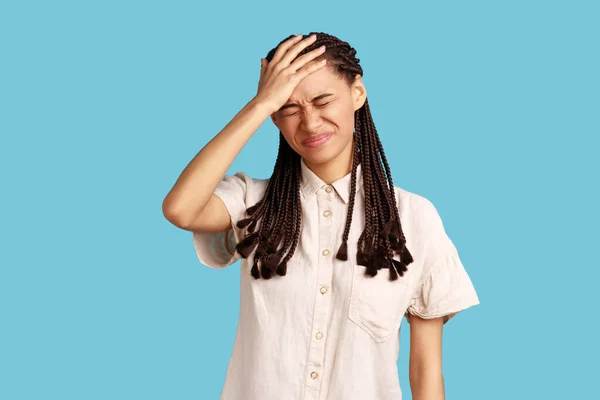 Portrait Displeased Woman Black Dreadlocks Keeping Hand Forehead Regrets Wrong —  Fotos de Stock