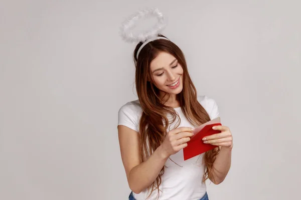 Portrait Charming Pleased Woman Nimbus Head Holding Red Envelope Reading — Stock Photo, Image