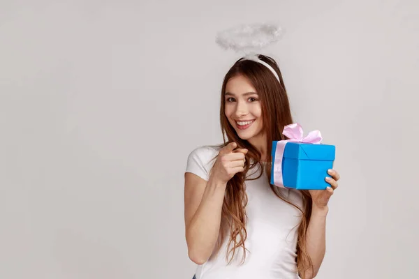 Portrait Beautiful Angelic Woman Halo Holding Gift Box Pointing Camera — Stock Photo, Image