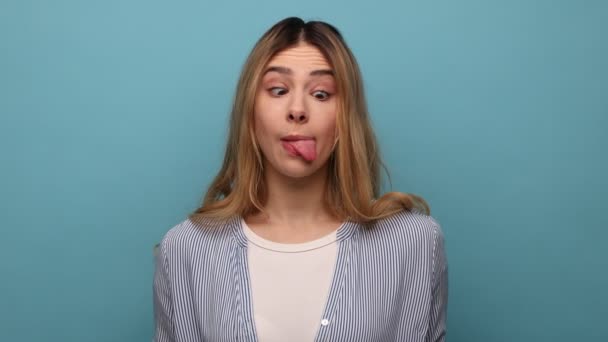 Funny Young Woman Crossing Eyes Showing Tongue Out Playing Fool — Stock video