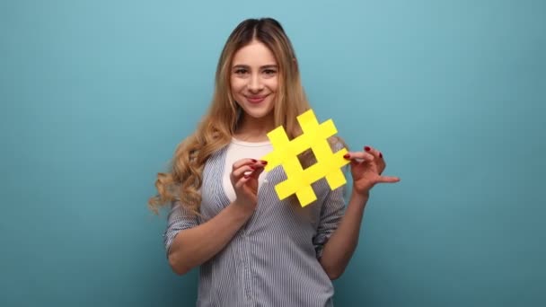 Smiling Beautiful Woman Holding Yellow Hashtag Symbol Making Important Topic — Stock Video