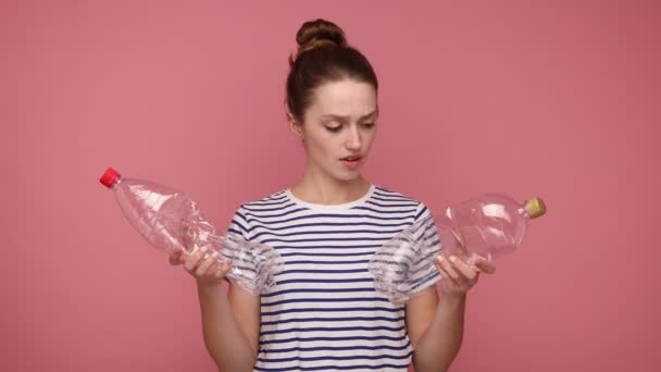 Puzzled Woman Hair Bun Holding Plastic Bottles Having Doubtful Expressing — Stock Video