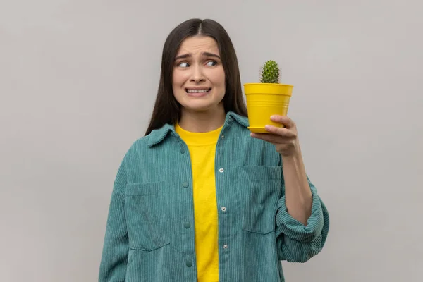 Portrait Scared Woman Holding Prickly Cactus Looking Plant Frowning Face — Stock Photo, Image