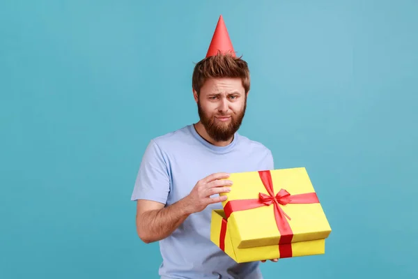Portrait Sad Bearded Man Party Cone Opening Gift Box Looking — стоковое фото