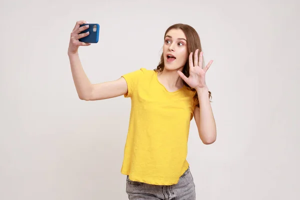Portrait Happy Curly Haired Teen Girl Yellow Shirt Taking Selfie — Foto de Stock