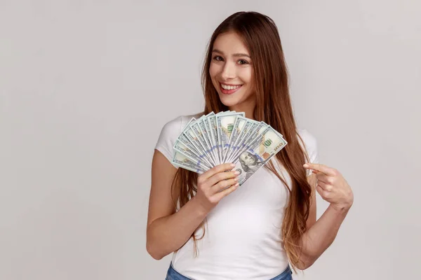 Portrait Smiling Woman Dark Hair Holding Fan Dollars Pointing Banknotes — Fotografia de Stock