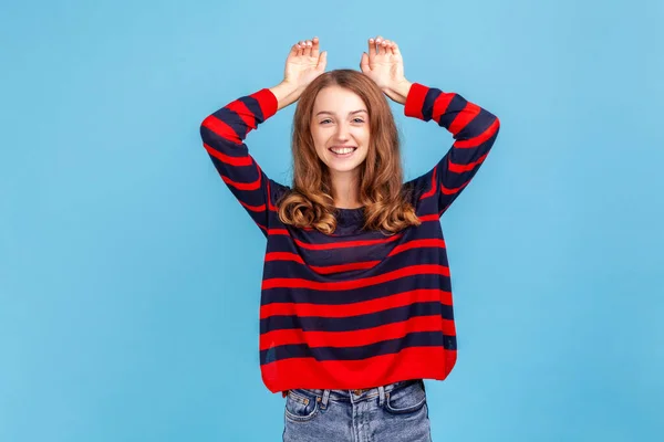 Portrait Cheerful Woman Wearing Striped Casual Style Sweater Showing Bunny — Stock fotografie