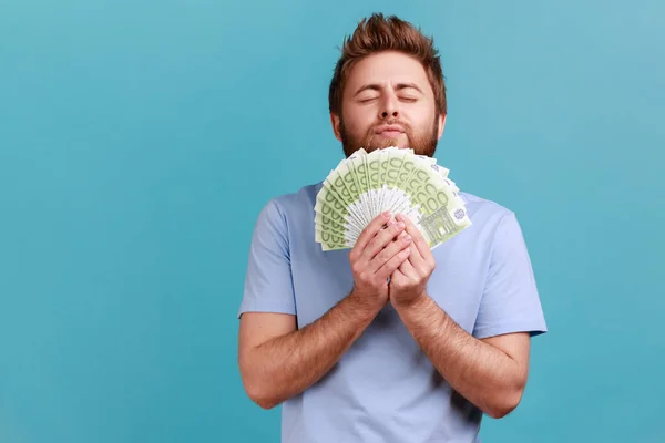 Portrait Satisfied Bearded Man Smelling Earned Euro Banknotes Enjoying Success — Stok fotoğraf