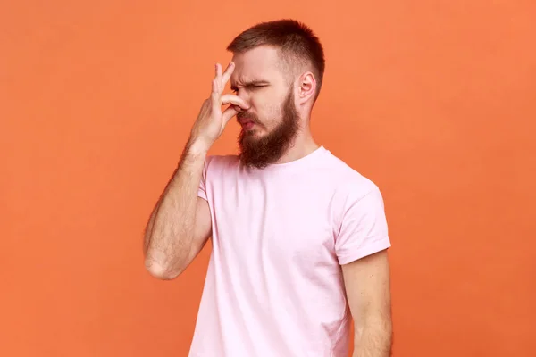 Portrait Confused Bearded Man Grabbing Nose Grimacing Disgust Expressing Repulsion —  Fotos de Stock