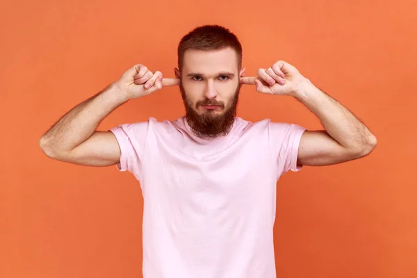 Portrait Bearded Man Closing Ears Fingers Seriously Looking Camera Tired — Fotografia de Stock