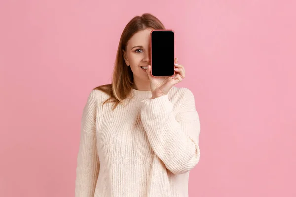 Portrait Smiling Blond Woman Covering Her Eye Smartphone Empty Display — Stock Photo, Image