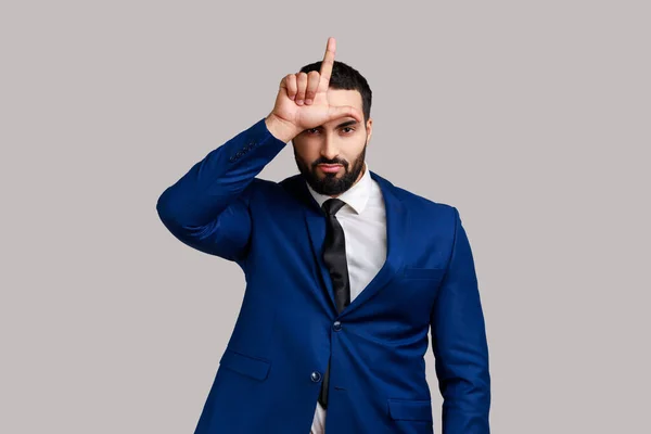 Portrait Upset Bearded Man Showing Loser Gesture Finger Sign Forehead — Stock fotografie