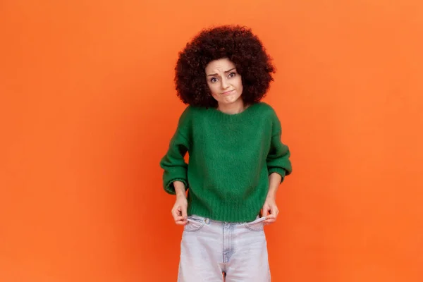 Bankrupt Unhappy Poor Woman Afro Hairstyle Green Sweater Showing Empty — Fotografia de Stock