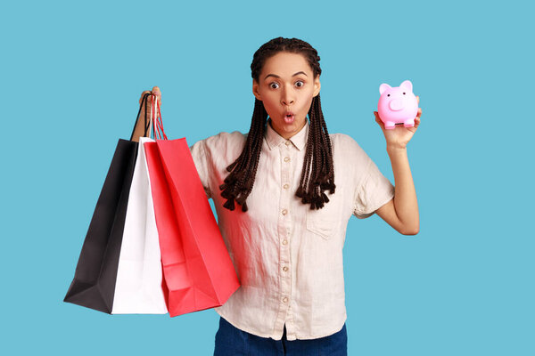 Astonished Amazed Woman Black Dreadlocks Holding Shopping Bags Piggy Bank Royalty Free Stock Photos