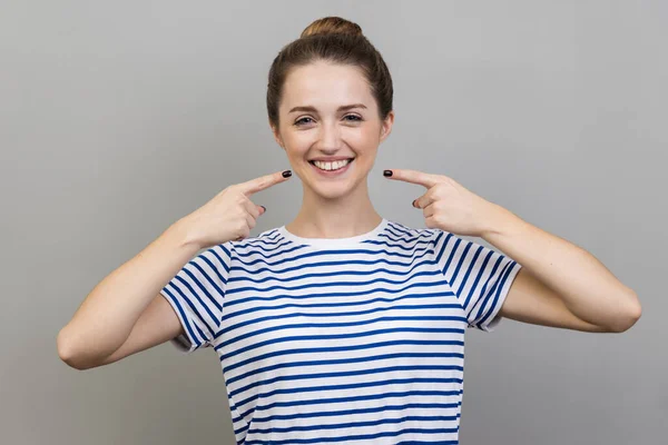 Portrait Pretty Cheerful Woman Wearing Striped Shirt Bun Hairstyle Points — 图库照片