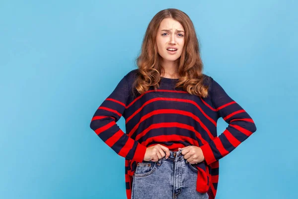 Upset Woman Wearing Striped Casual Style Sweater Trying Close Buttons — ストック写真