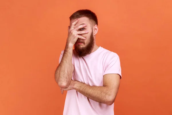 Portrait Curious Bearded Man Spying Hole Fingers Closing Eyes Arm — Stockfoto